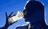 a man drinks from a cup that says tommy cash on it