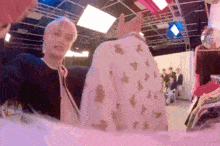a blurry picture of a man holding a sweater