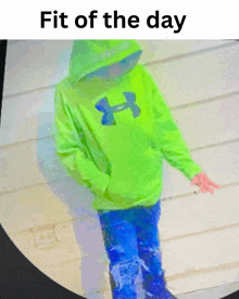 a child wearing a green under armour hoodie