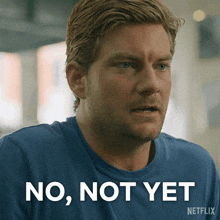 a man in a blue shirt with the words no not yet on the bottom