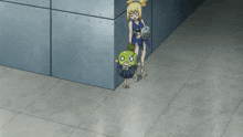 a girl in a blue dress is standing in a corner next to a green object