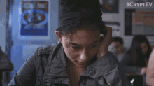 a girl with curly hair is sitting in a classroom with a #crypttv watermark