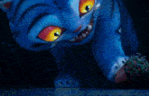 a blue cat with yellow eyes is looking at something