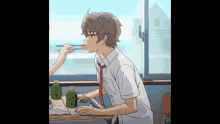 a boy and a girl are sitting at a table with chopsticks and bottles of green tea