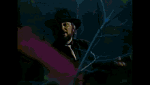 a man with a beard wearing a hat and tie is in the water