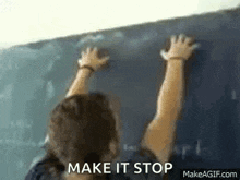 a woman is writing on a blackboard in a classroom .
