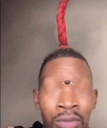 a man with a red scarf on his head and a third eye .