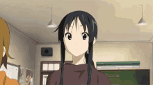 a girl with long black hair is standing in a room with other girls