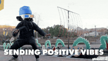 a man wearing a blue hat and 3d glasses is standing in front of a ship and the words sending positive vibes