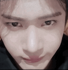 a close up of a person 's face with a shadow on their nose .