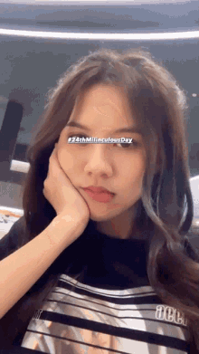 a girl with her hand on her face and the words # 24th milinculous day visible