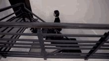a woman is walking up a set of stairs