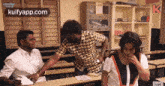 a group of people are sitting in a classroom .