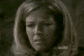a close up of a woman 's face with lorihg on the bottom left