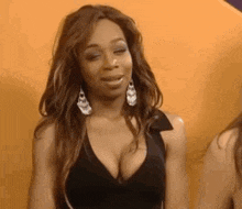 a woman with a very large breast is wearing a black dress .