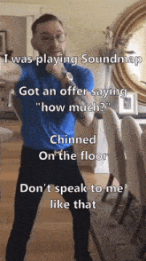 a man in a blue shirt is standing in front of a dining room table and chairs while playing soundmap