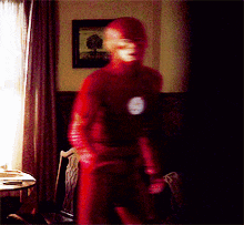 a blurry picture of a man in a red flash costume