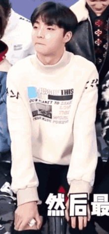 a young man wearing a sweater that says our planet to save