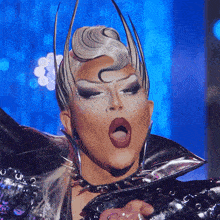 a drag queen with a crown on her head