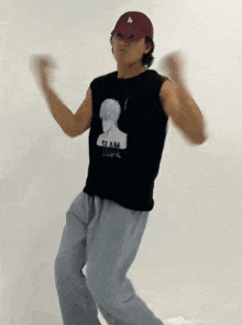 a man wearing a hat and a black shirt that says slam on it