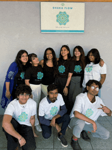 a group of people posing in front of a sign that says chaka flow