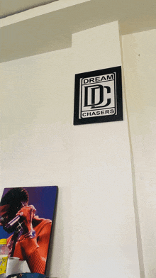 a dream chasers sign hangs on a wall