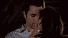 a man and a woman are kissing and hugging