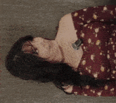 a woman in a floral dress is laying down