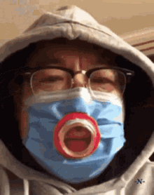 a person wearing a face mask with a pacifier in their mouth .