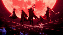 a group of people standing in front of a full moon