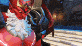 a statue of a demon with a beard and horns on his head