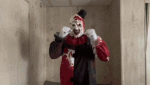 a scary clown in a red and black costume