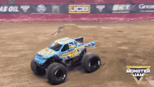 a monster jam truck is driving through a dirt track
