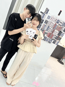 a boy and a girl are posing for a picture and the boy has a case that says supreme on it
