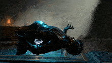 a video game character is laying on the ground with a blue light coming out of his chest