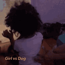 a little girl with curly hair is being held by a person with the words girl vs dog above her