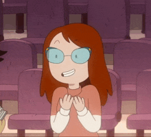 a cartoon girl wearing glasses is sitting in a theater