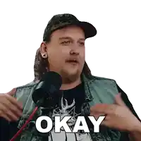 a man in a hat and vest says okay