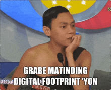 a shirtless man sitting in front of a microphone with the words grabe matinding digital footprint yon written below him