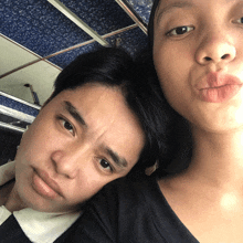 a woman making a funny face next to a man
