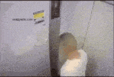 a man in a white shirt is standing in front of a sign that says crazyshit.com