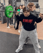 a man squatting with a rogue barbell