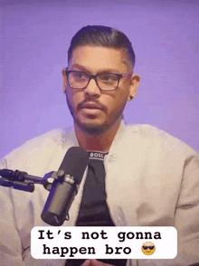 a man talking into a microphone with the words " it 's not gonna happen bro " below him