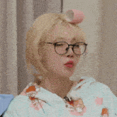 a woman wearing glasses has a pink curler on her head and the words " no brain " written in red