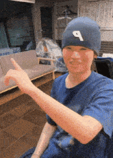a man wearing a black hat with the letter p on it