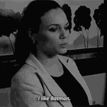 a black and white photo of a woman talking about batman