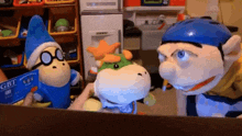 two stuffed animals are standing next to each other in a room .