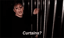 a man in a cage with the words curtains written on the bottom