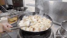 a person is stirring food in a wok on a stove that is made in animotica