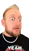 a man with a beard is wearing a yeah shirt